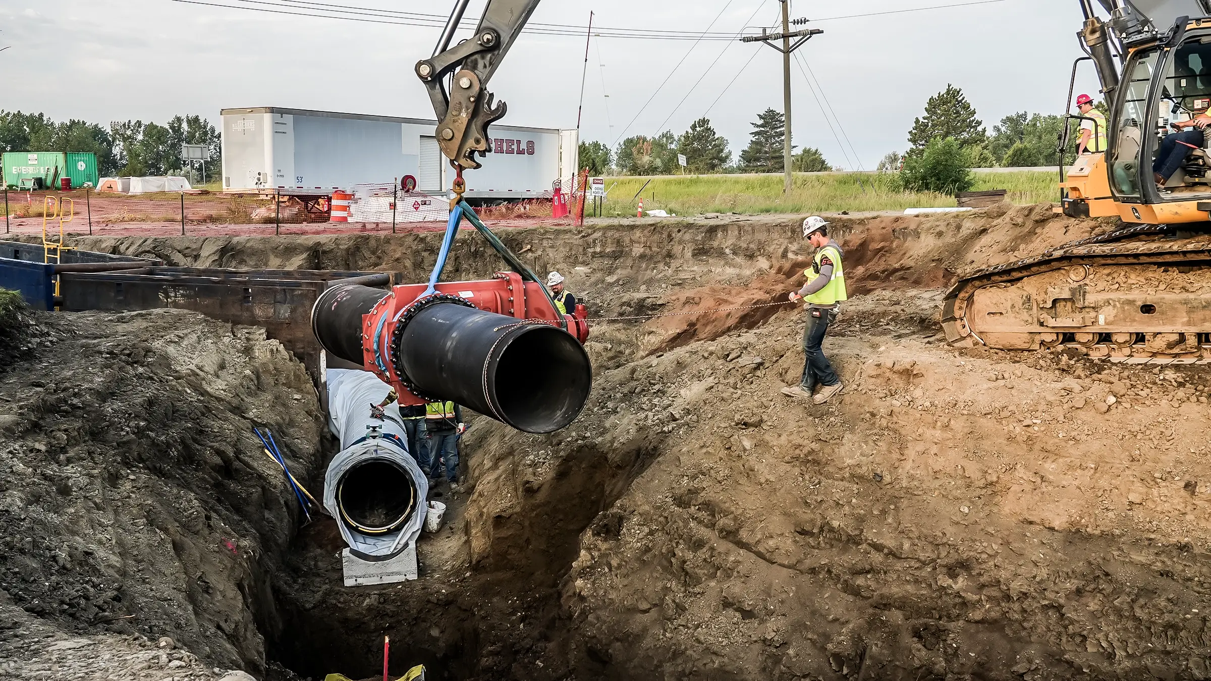 A portion of pipeline being lowered into a trench.