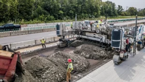 A paving machine paves a major interstate.