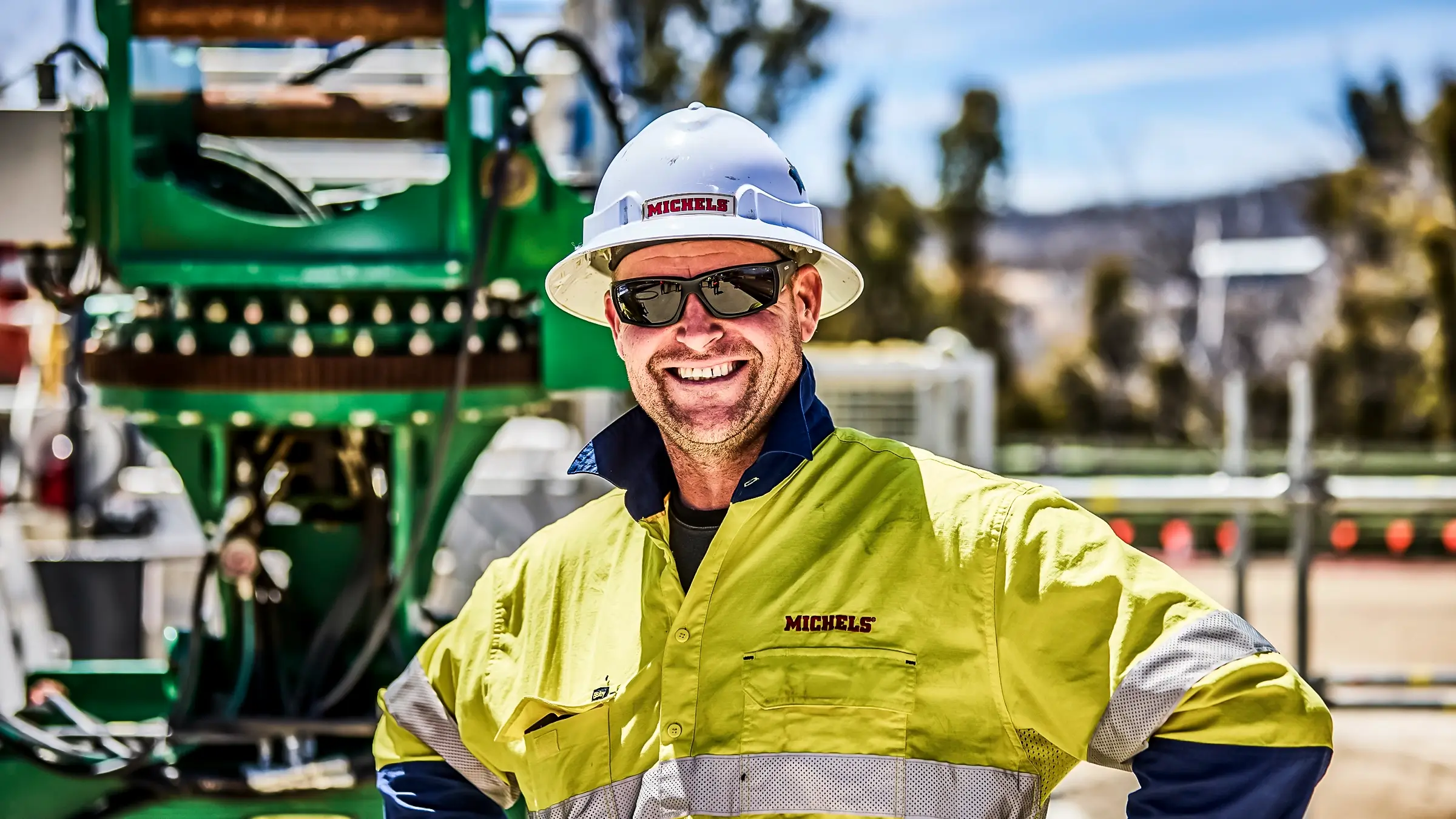 A crew member smiling happily on a jobsite