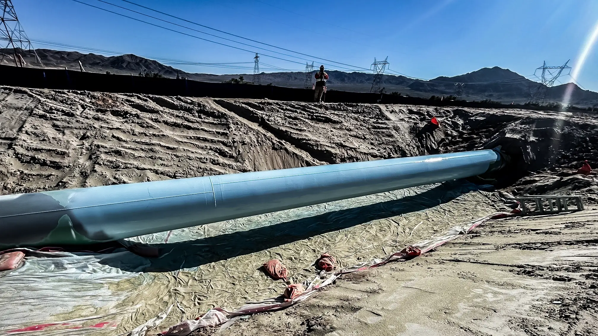 New pipeline runs through a desert trench.