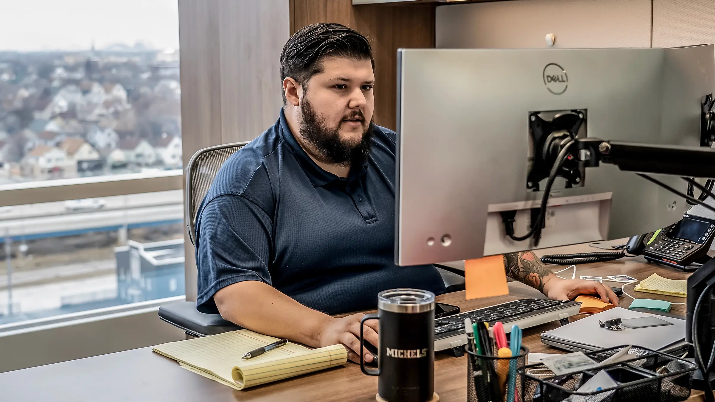 A man working behind a computer screen.