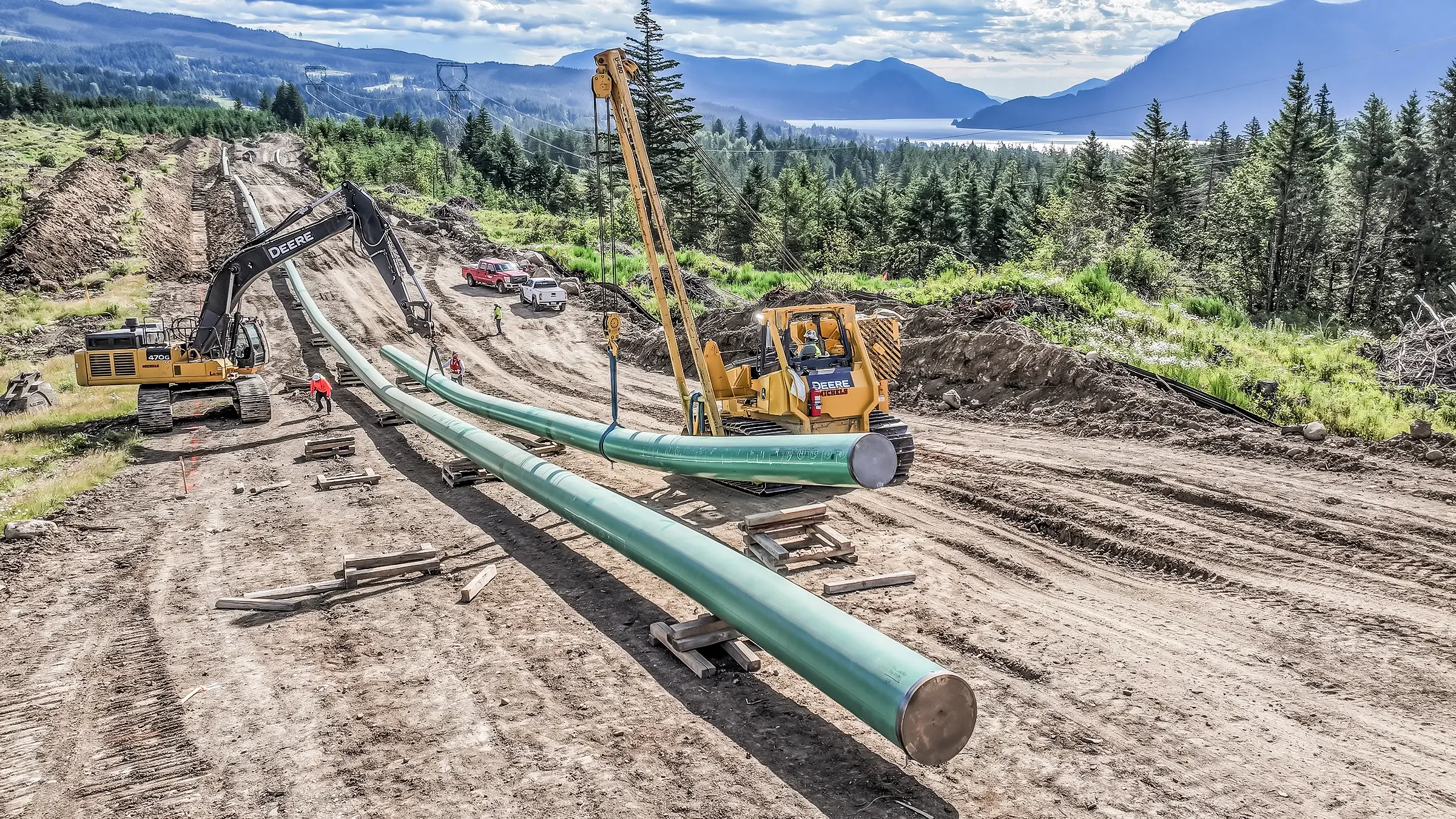 Large diameter pipeline laid out in a rural forest.