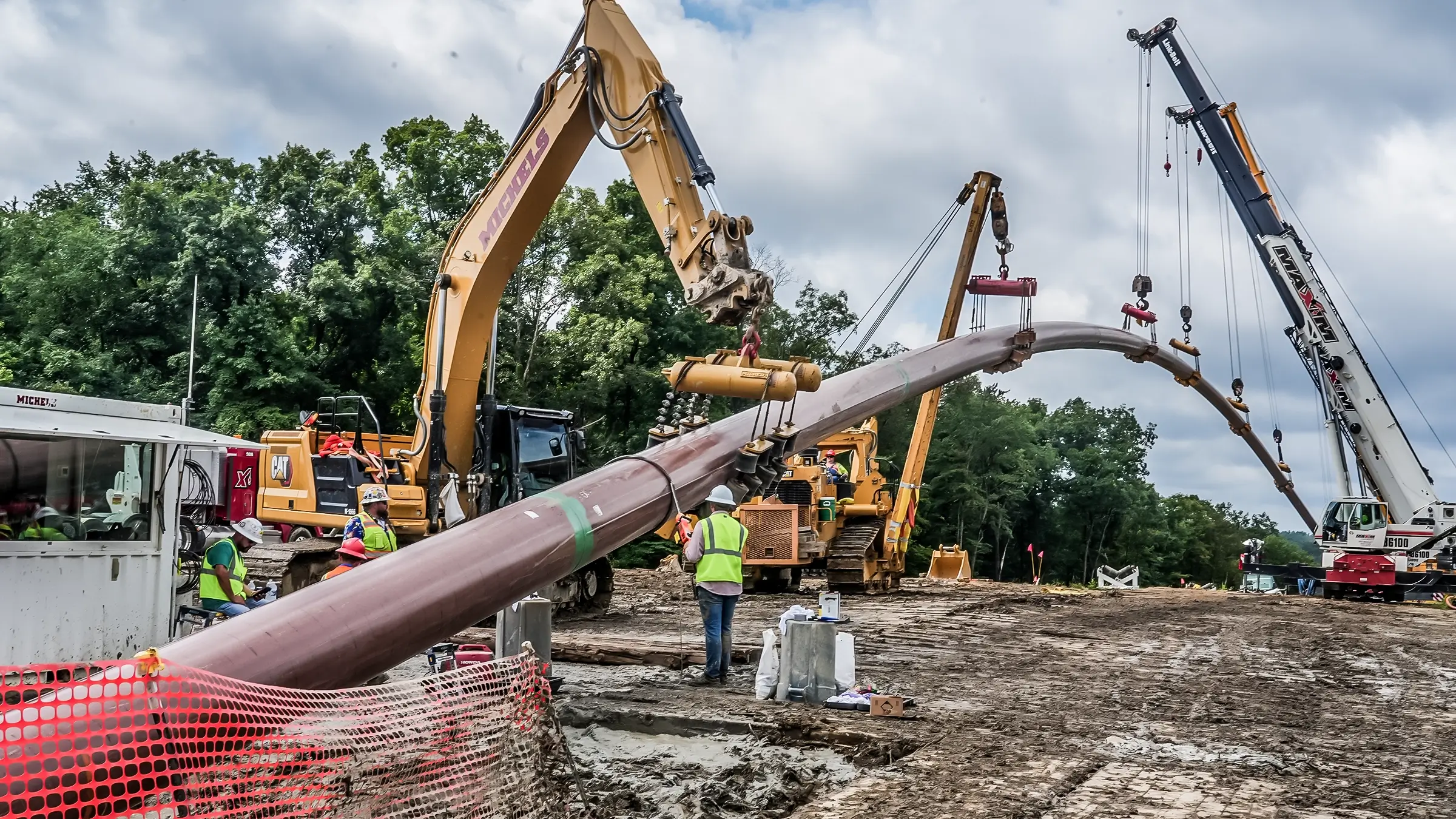 Large diameter pipeline is directed into the ground.